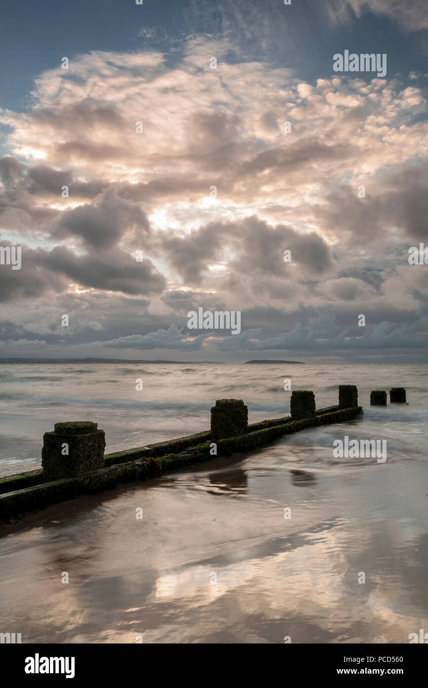 Groynes on the beach at Penmaenmawr on the North Wales coast Stock Photo