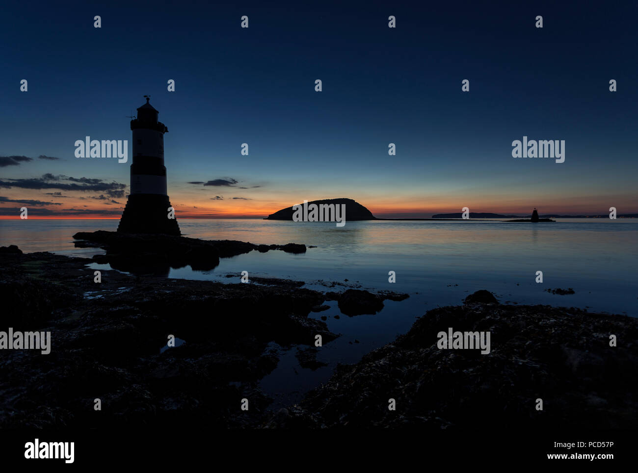 Lighthouse at Penmon Point, Anglesey, North Wales with Puffin Island in the background at dawn Stock Photo