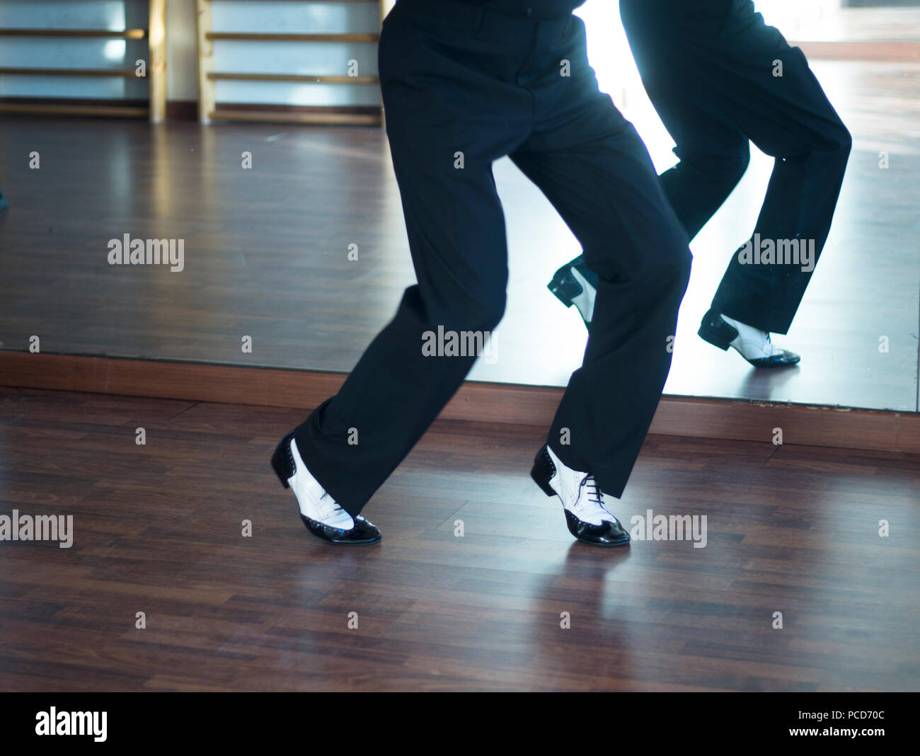 Ballroom dance salsa dancer instructors man and woman couple dancing in shcool rehearsal room Stock Photo