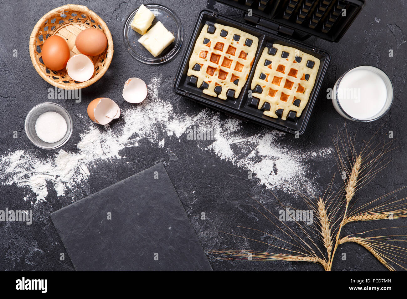 Photo on top of ingredients for viennese waffles, waffle iron, spikes