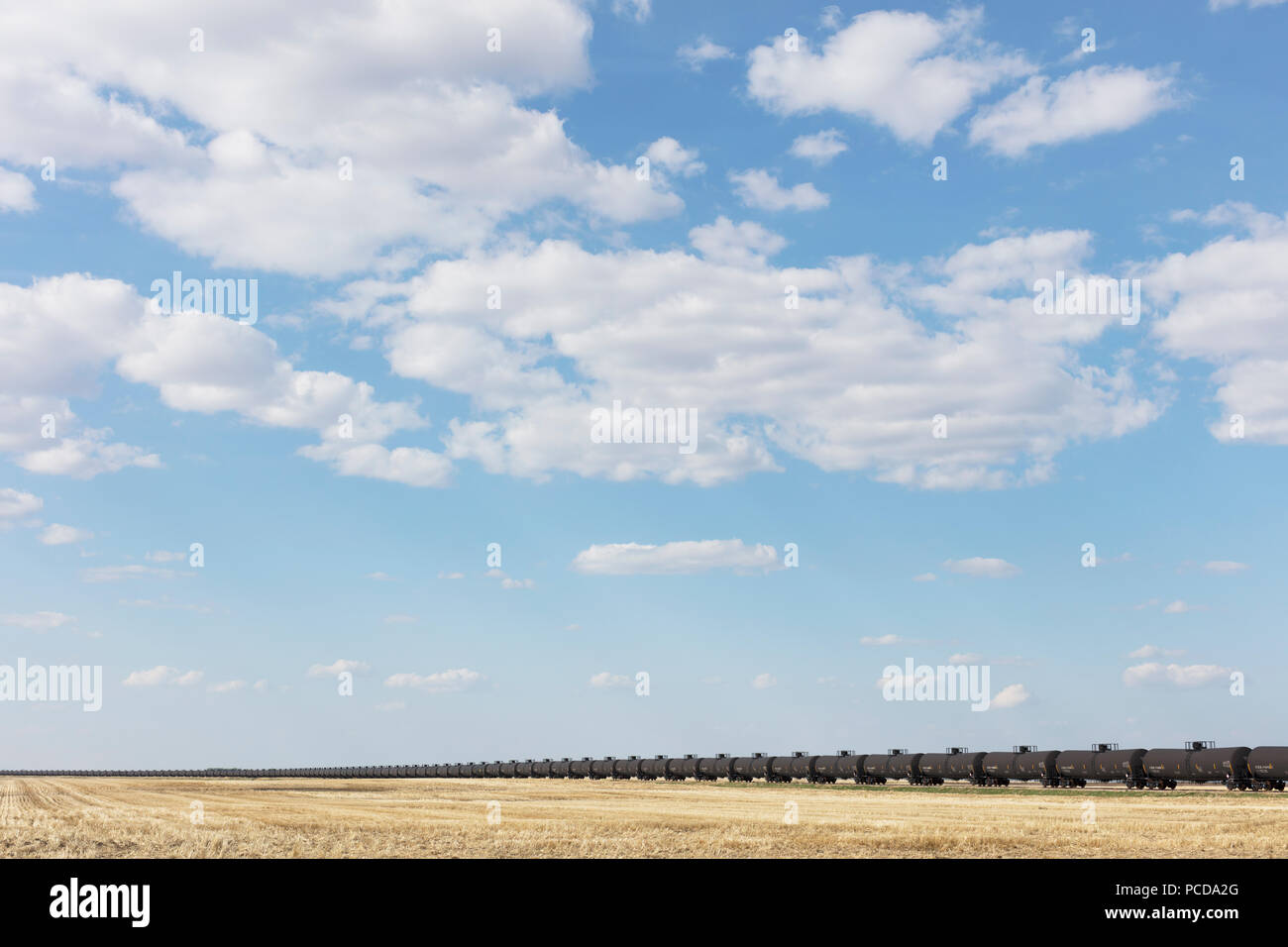 Oil train cars and fallow farmland, near Swift Current, Saskatchewan, Canada. Stock Photo