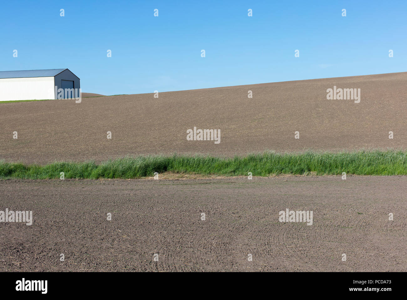 Farmland and barn in fallow field Stock Photo - Alamy