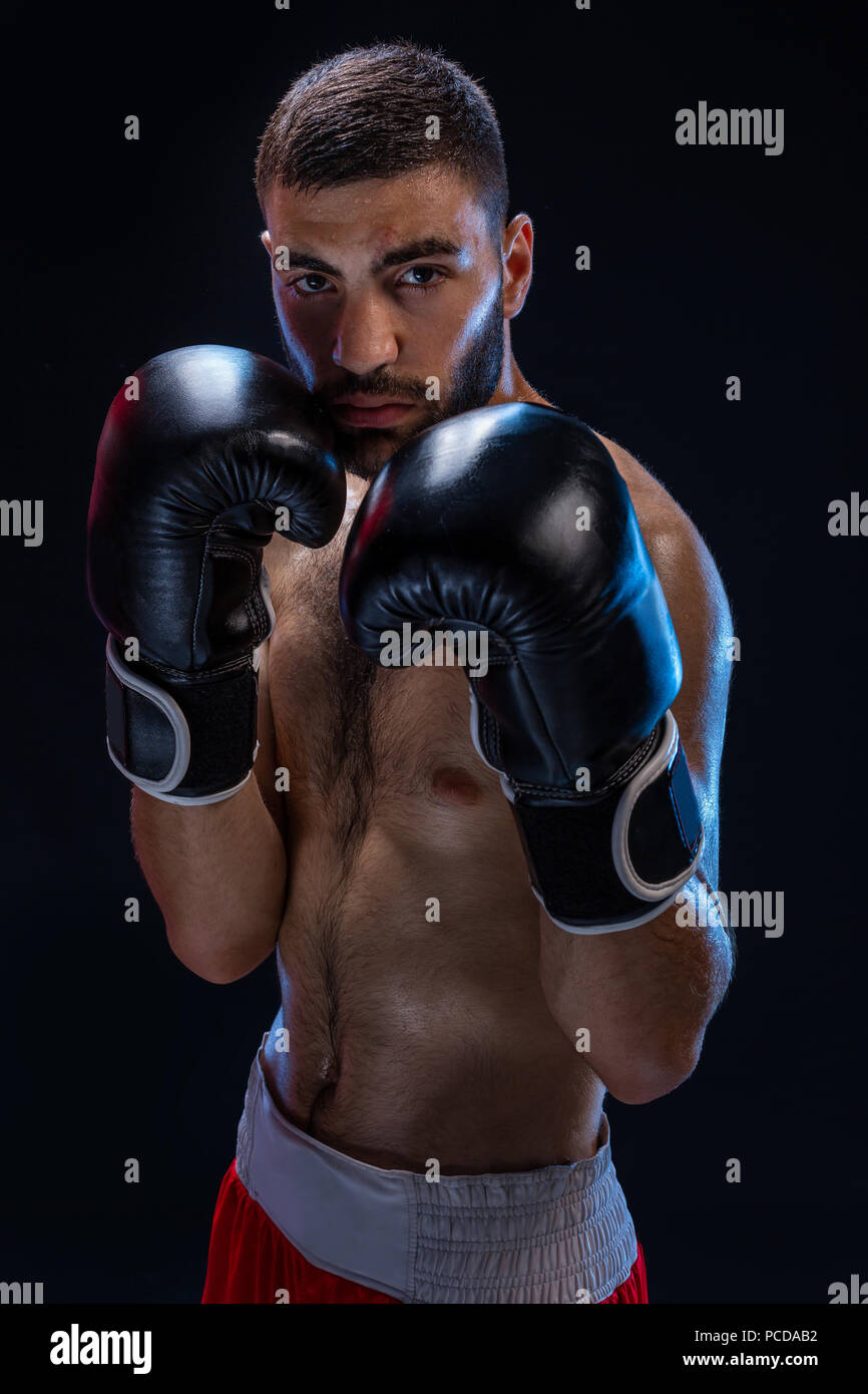 Double arm block. Boxing trainer showing defensive techniques. Combat sport, fight club. Studio