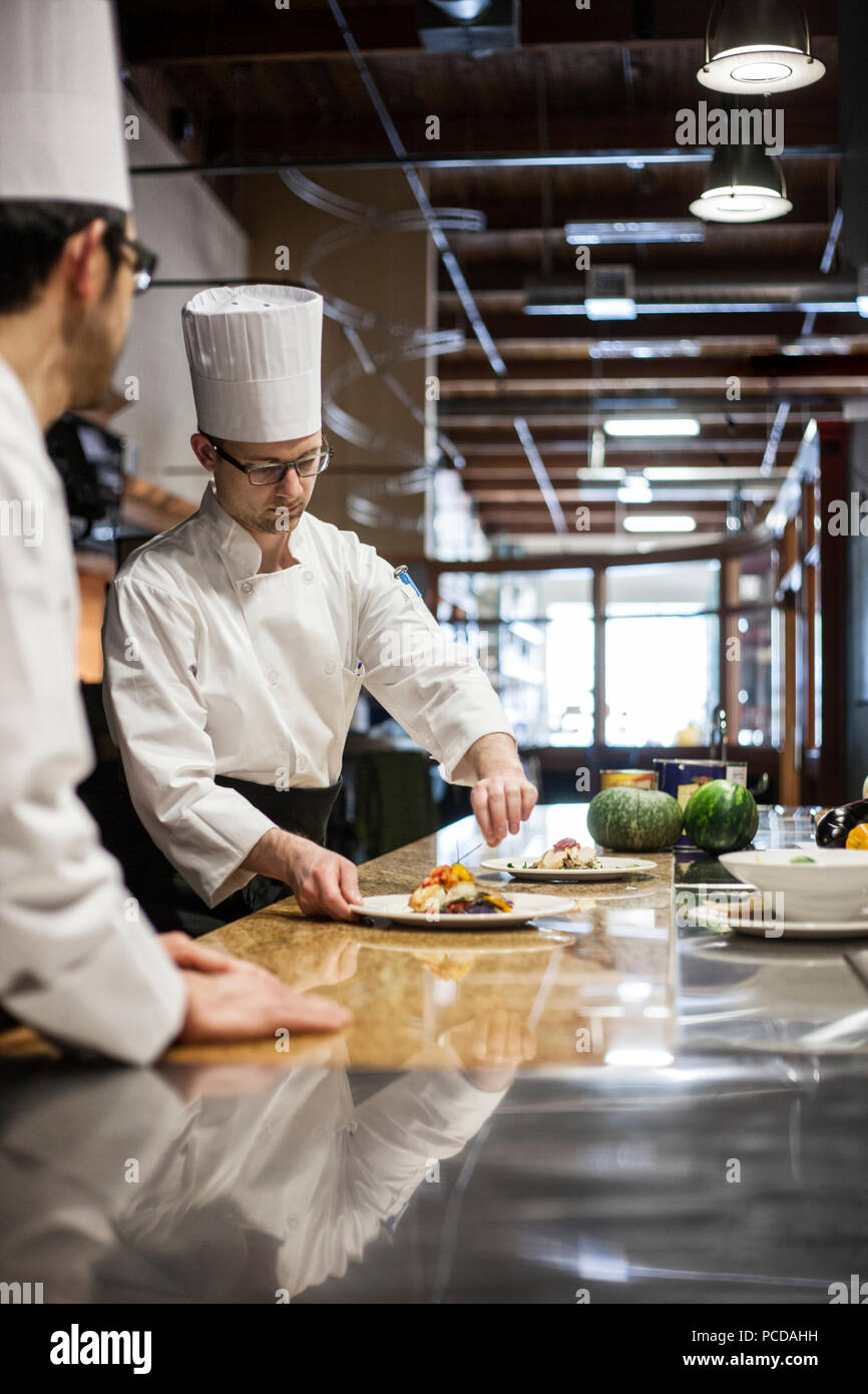 A crew of chef's working in a commercial kitchen Stock Photo Alamy