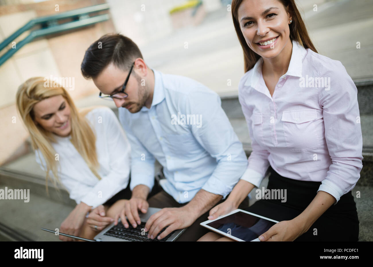 Workteam in office working together on laptop Stock Photo - Alamy