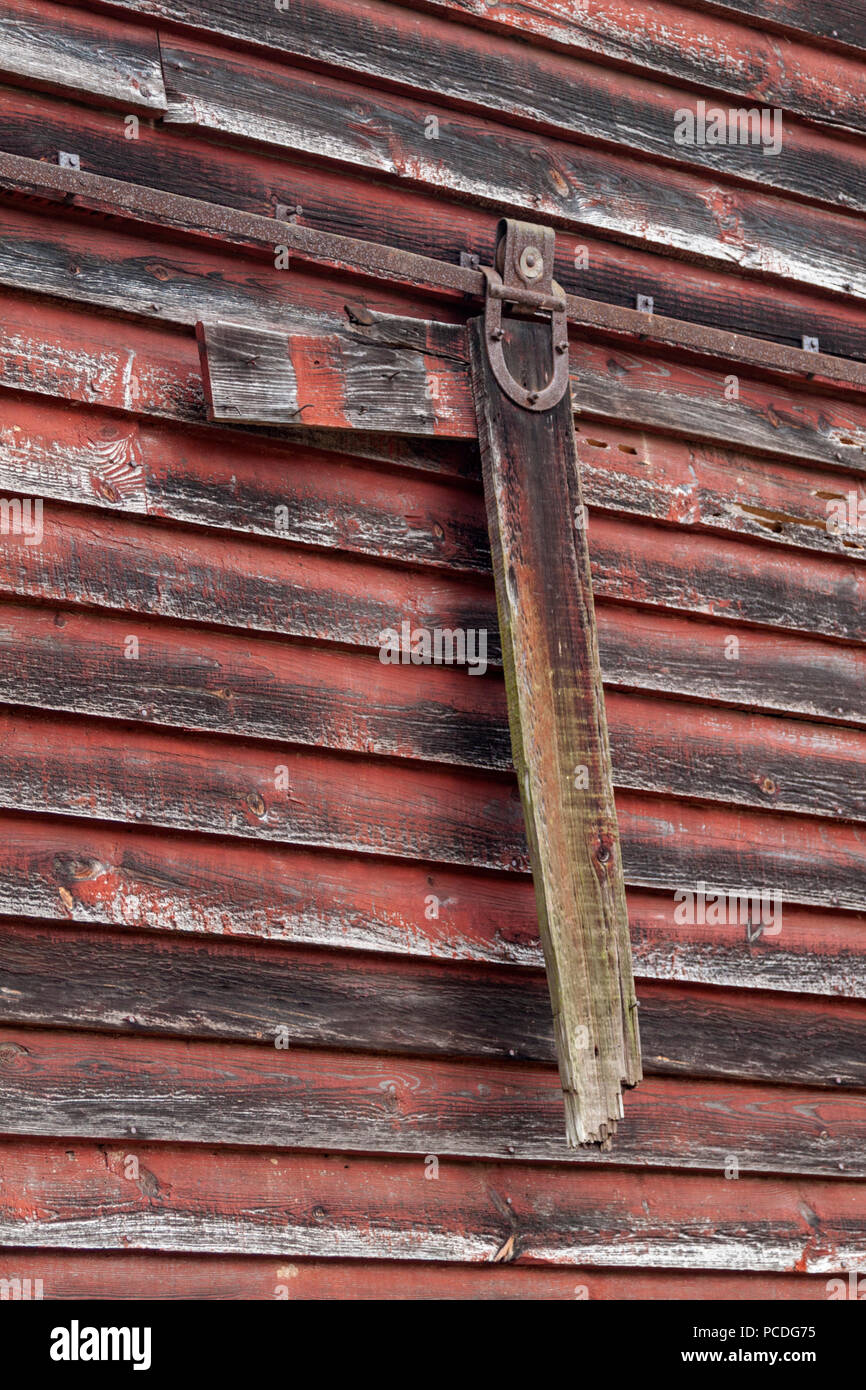 Close-up of a broken, sliding door parts, hanging off the side of a barn in Cades Cove in the Great Smoky Mountains National Park near Townsend, Tenn. Stock Photo
