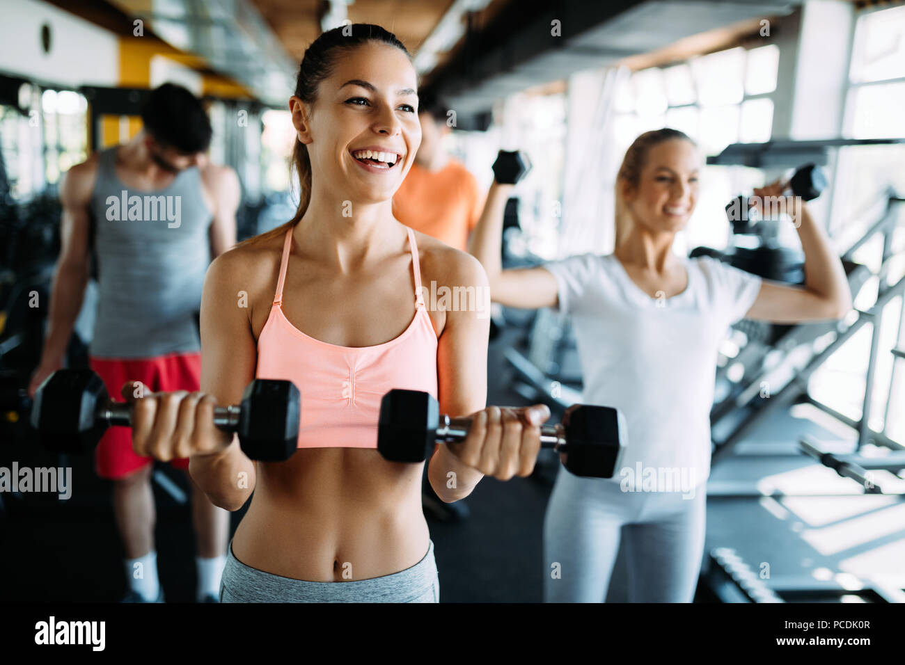 Picture of cheerful fitness team in gym Stock Photo - Alamy