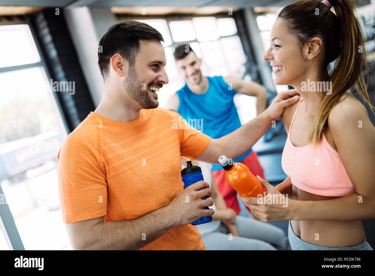 Young beautiful woman doing exercises with personal trainer Stock Photo