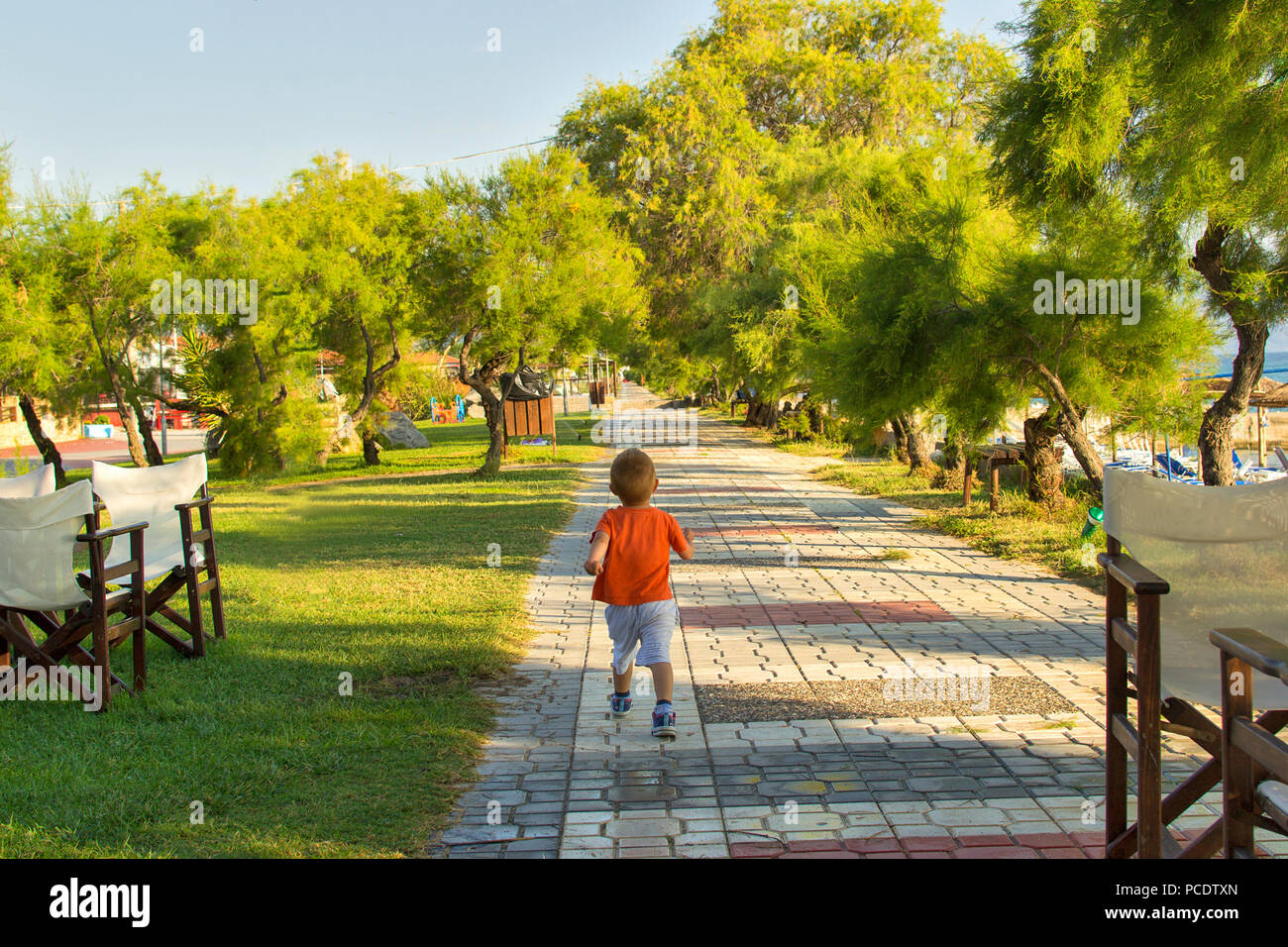 Boy walking in park near beach. Ierissos, Greece. Stock Photo