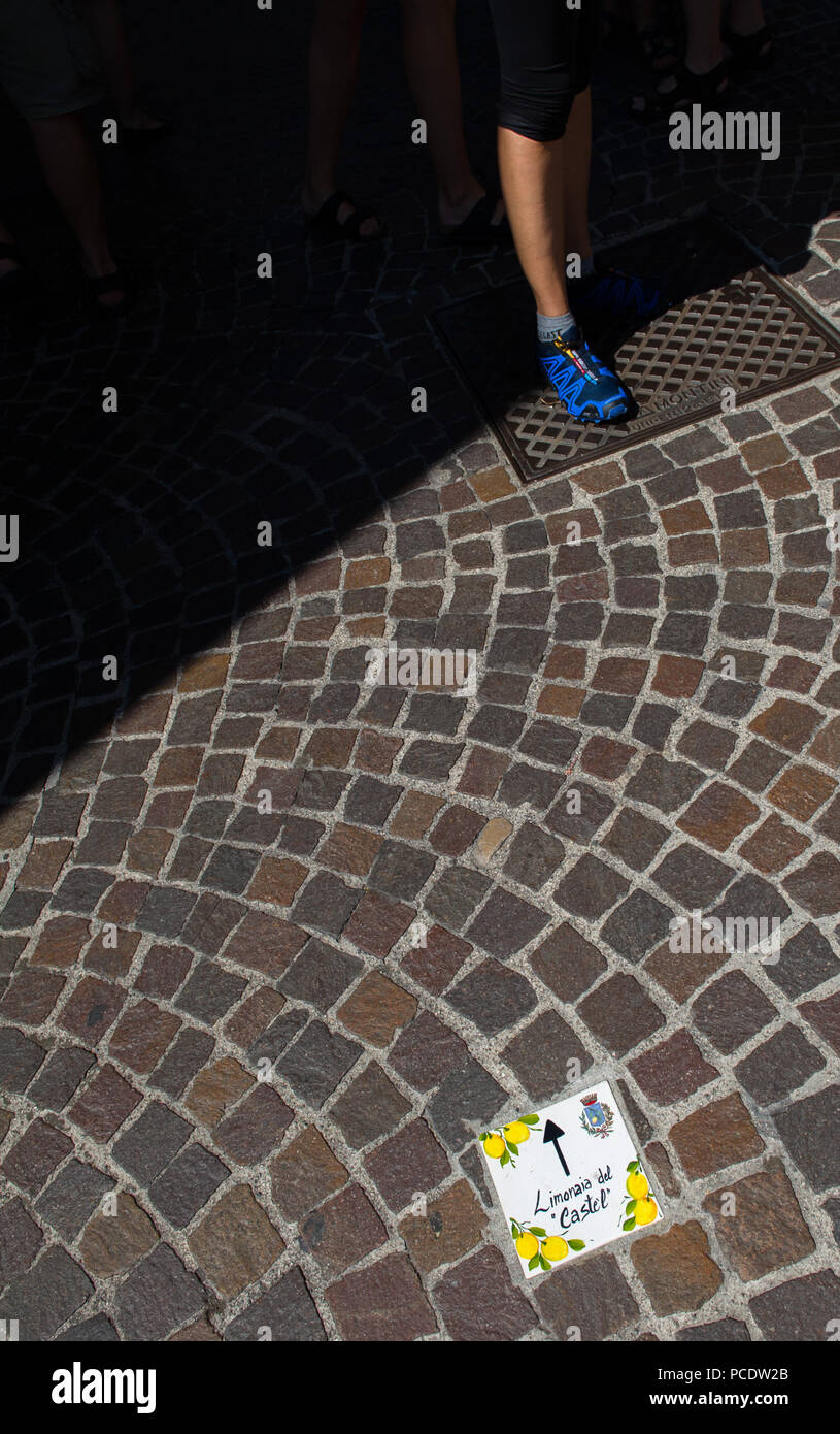 Decorative ceramic floor tiles showing the direction to the lemon castle in Limone, Italy. Stock Photo