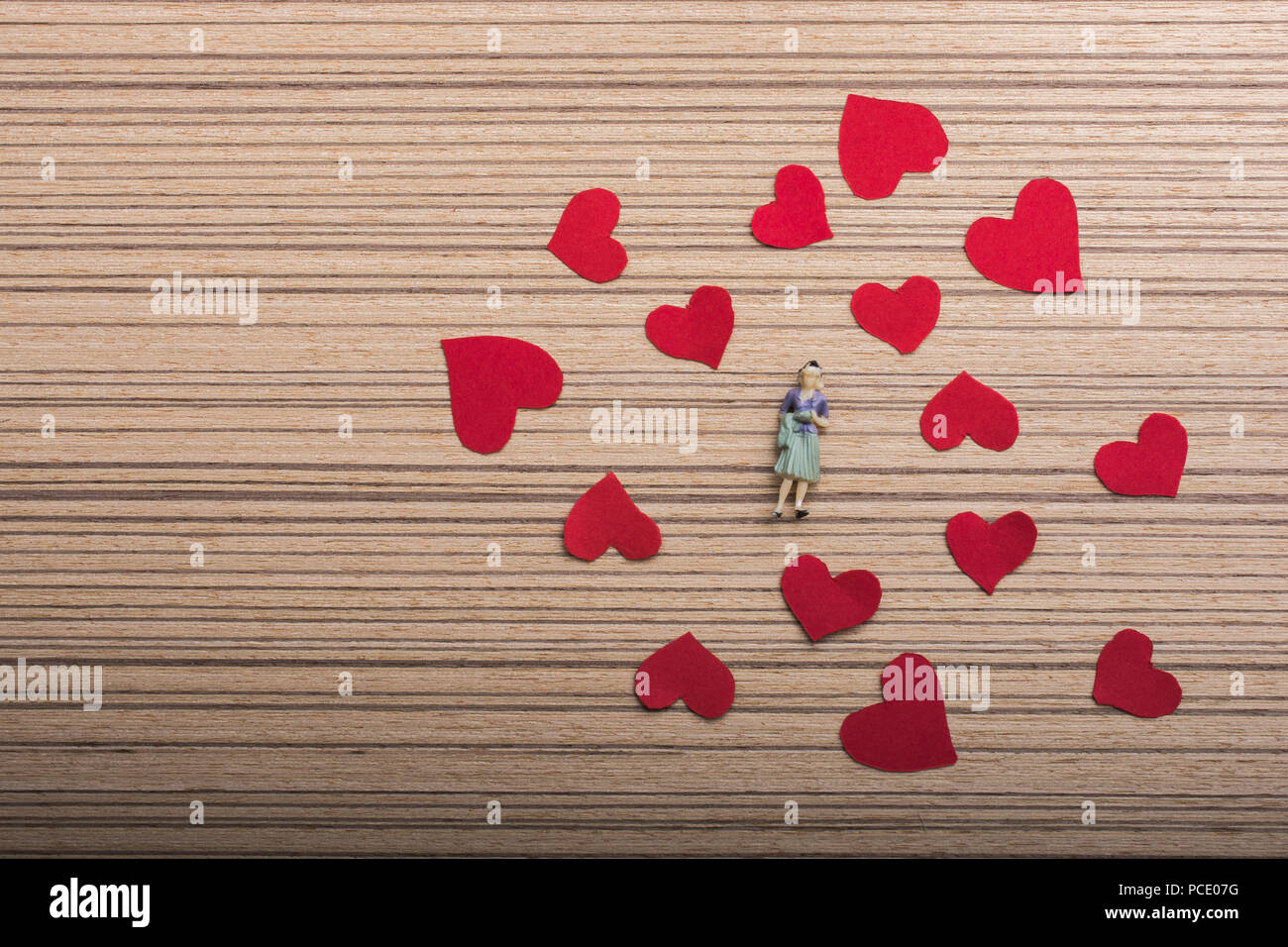 Woman figurine and Love concept with red paper hearts Stock Photo - Alamy