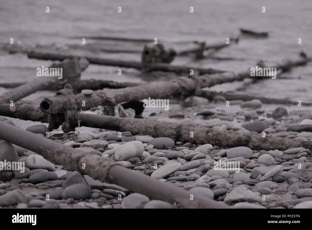 Pebbles & Poles on Scottish Beach Stock Photo