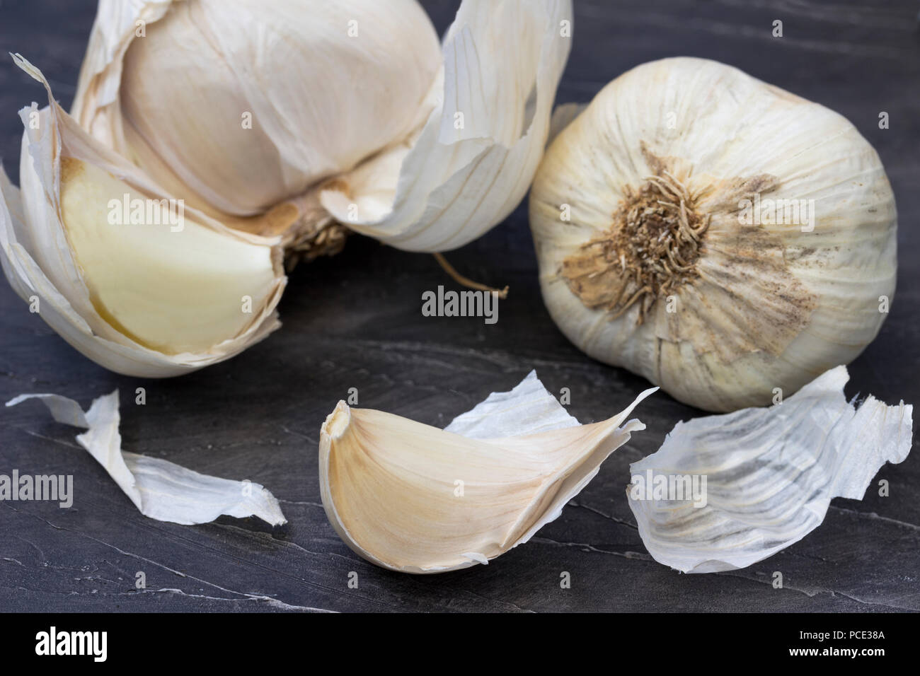 Garlic bulbs with garlic cloves on the wooden background Stock Photo