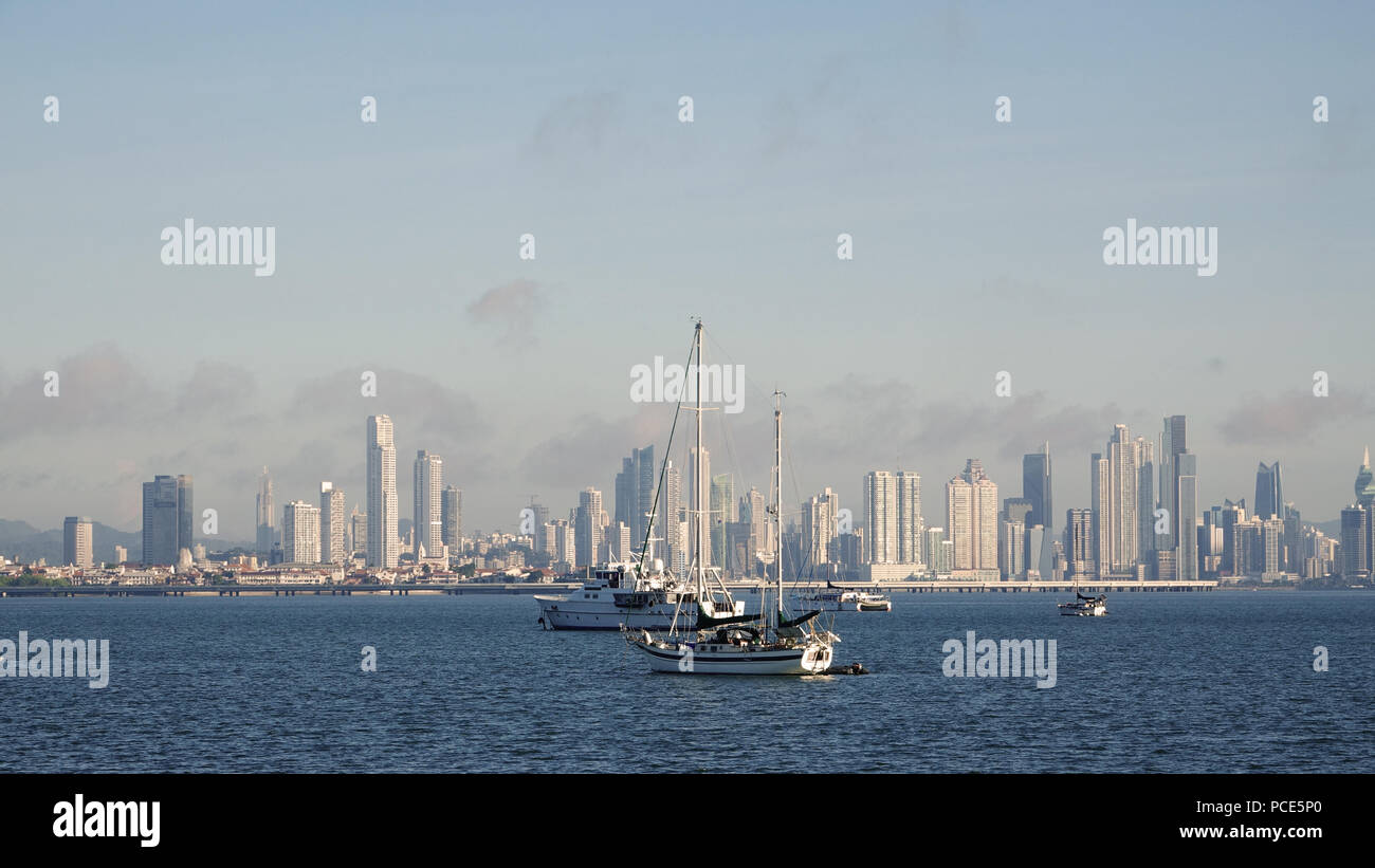 Luxury boats anchored at sea with the impressive skyline of Panama City