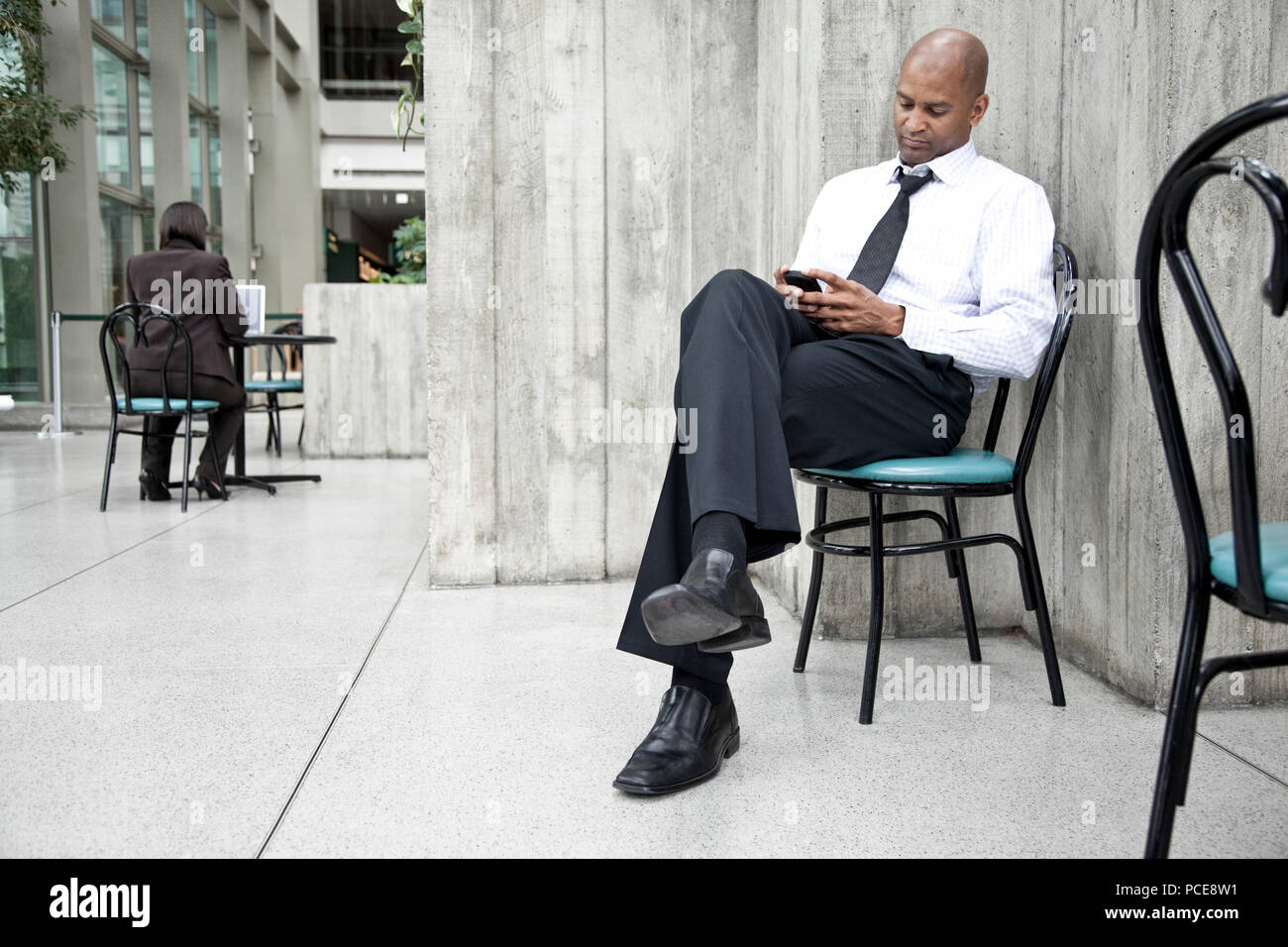 A black businessman texing on his cell phone. Stock Photo