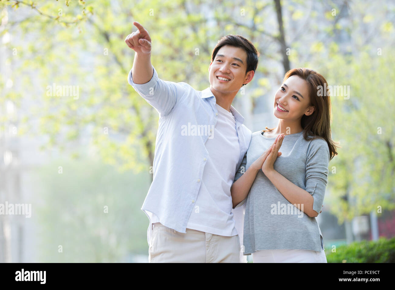 Young happy asian couple thinking hi-res stock photography and images ...