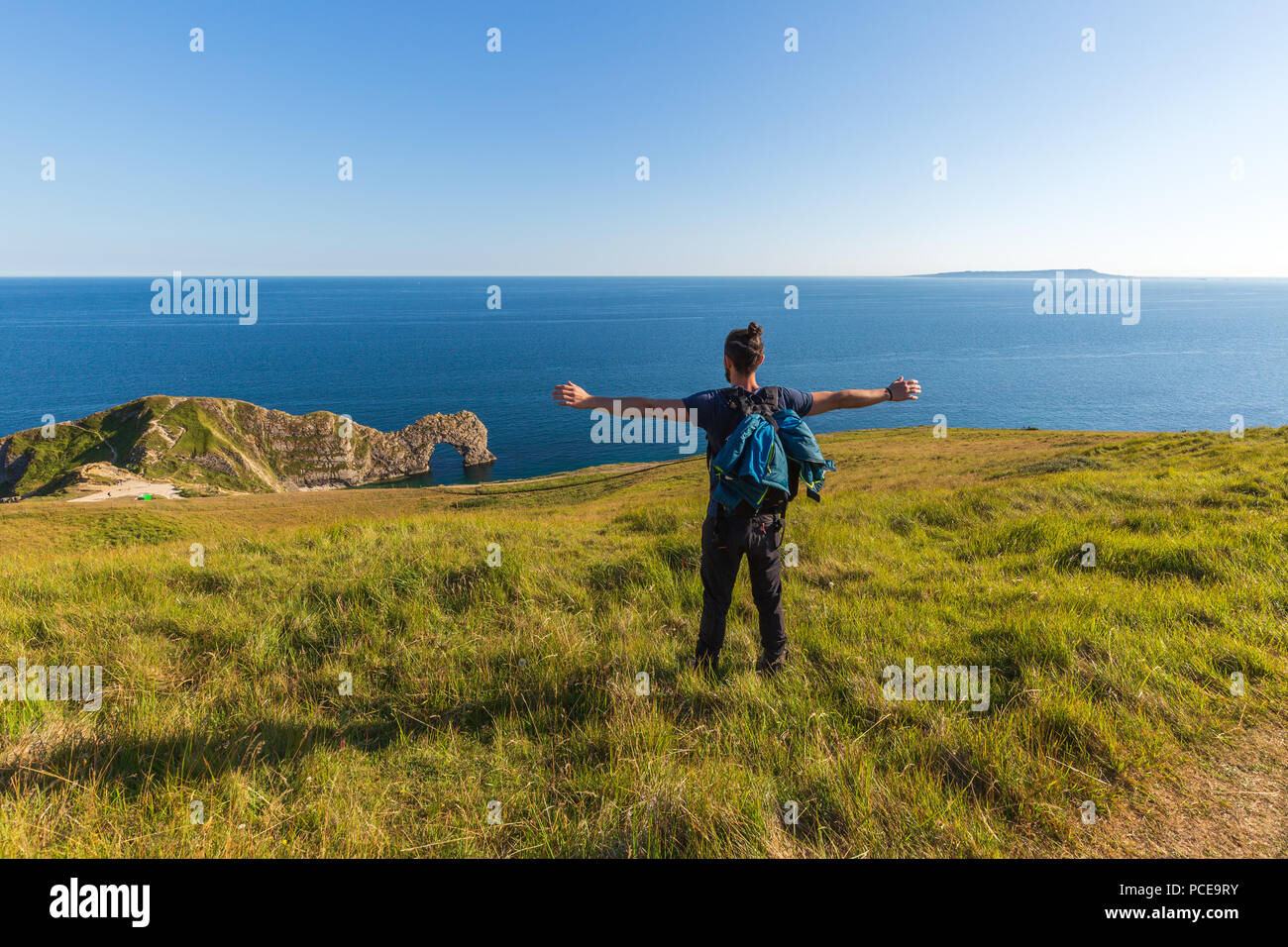 A man looking at the horizon at the most beautiful photography spots on the south west coast of England, on the jurassic coast Stock Photo