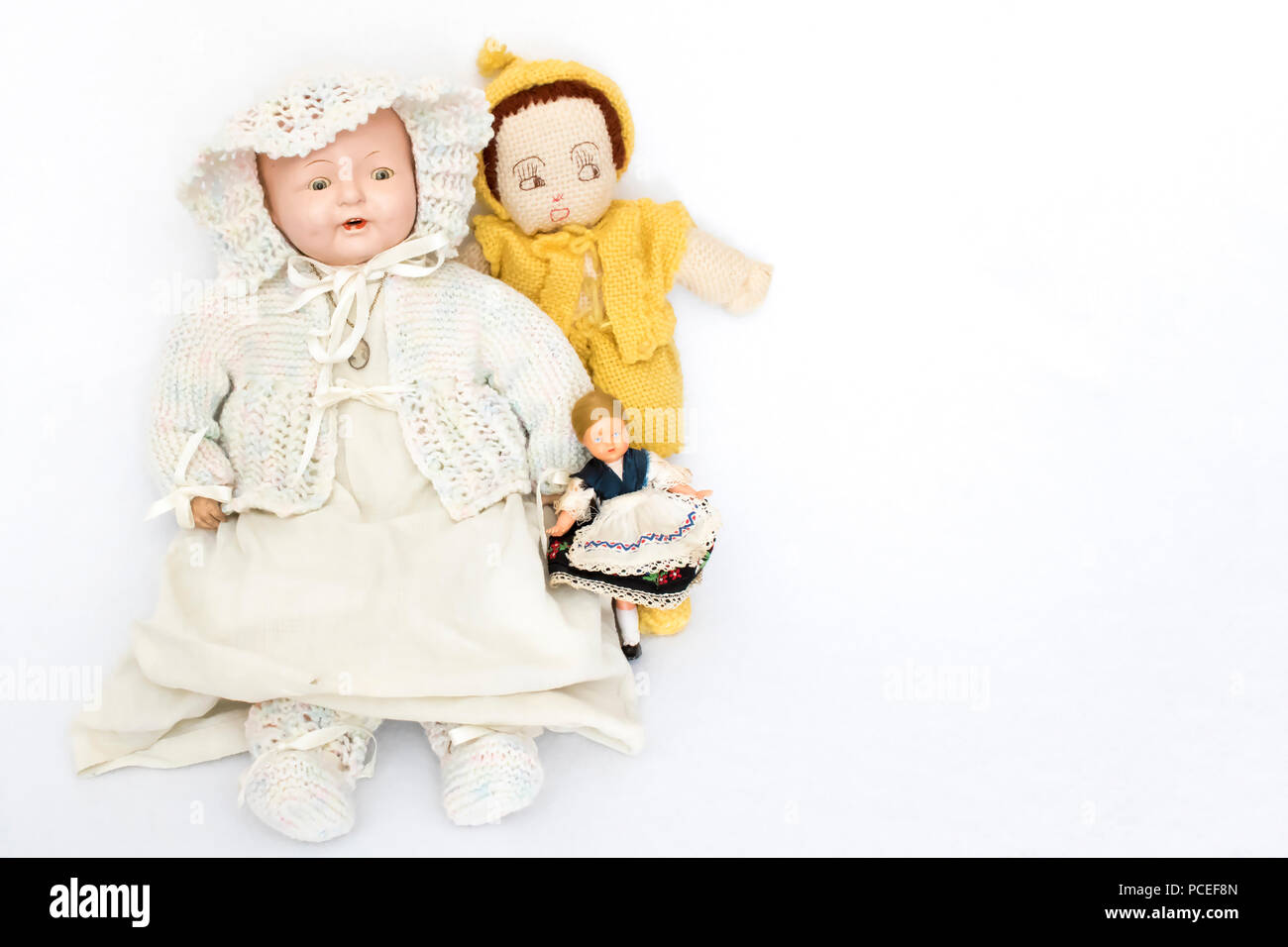 Three Antique Dolls on White Background Stock Photo