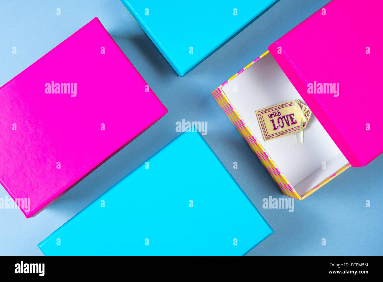 Two pink boxes and two light blue boxes in the shape of a cross with a ...