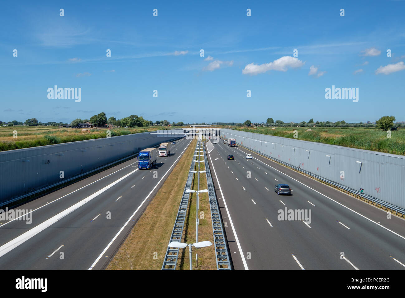 SCHIEDAM, NETHERLANDS - JUL 31, 2018 :  Highway A4, Delft-Schiedam, Netherlands. This modern highway is built in a deepened location to save the Midde Stock Photo