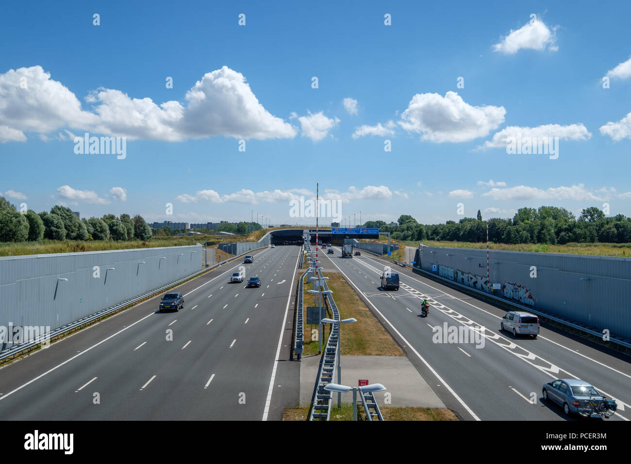 SCHIEDAM, NETHERLANDS - JUL 31, 2018 : Modern deepened Highway A4, leading into a tunnel under the urban area close to Rotterdam Netherlands. The deep Stock Photo