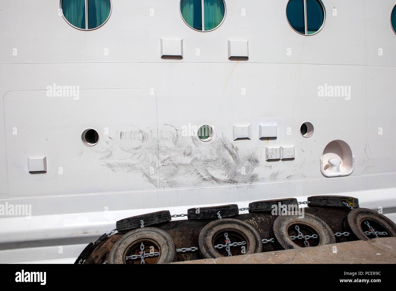 Floating Jetty Rubber Fender bumpers making black tyre marks on Independence of the Seas cruise ship while docked Stock Photo