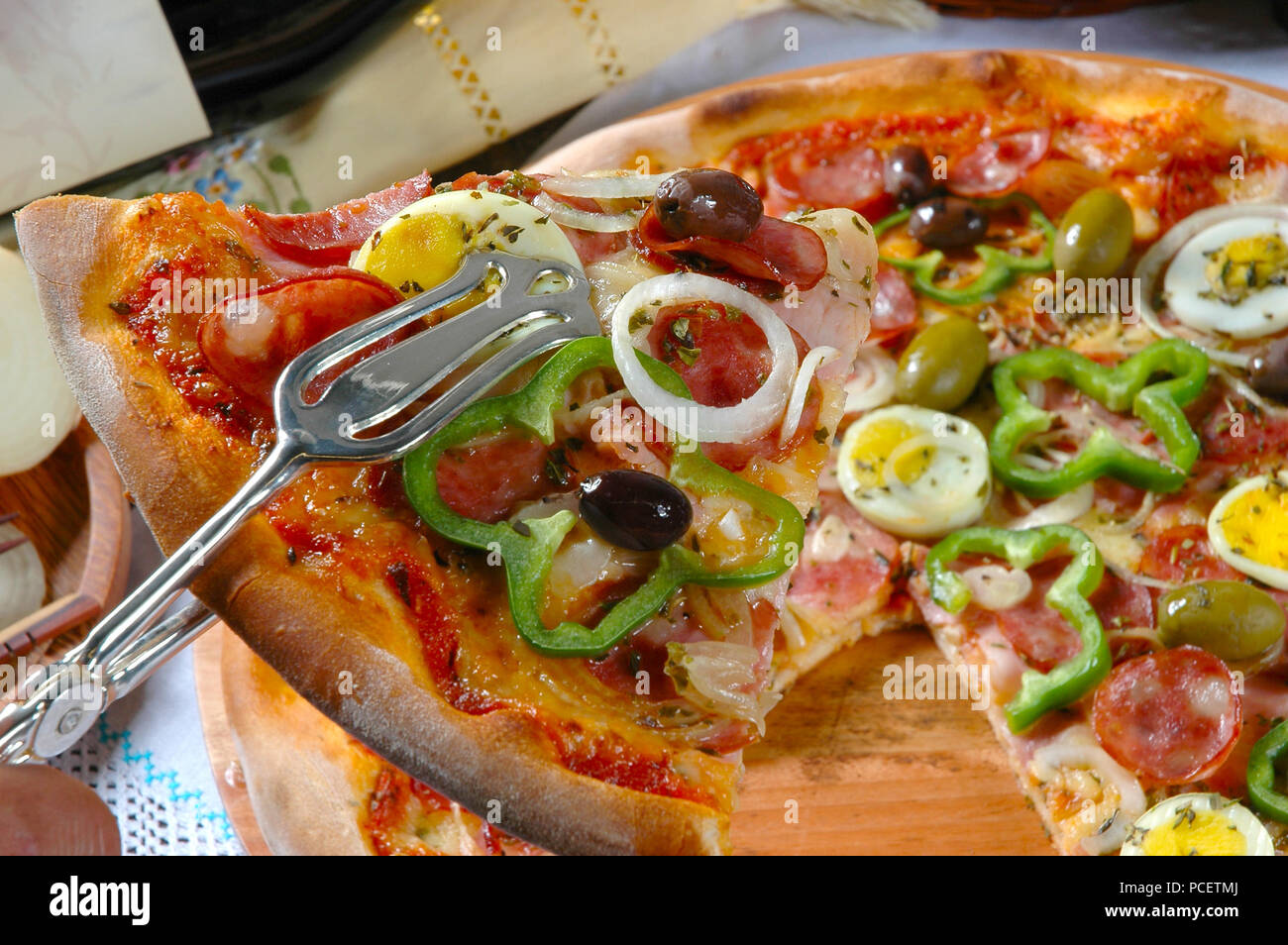 Portuguese Pizza, onion, peppers, pepperoni, egg, olive Stock Photo Alamy