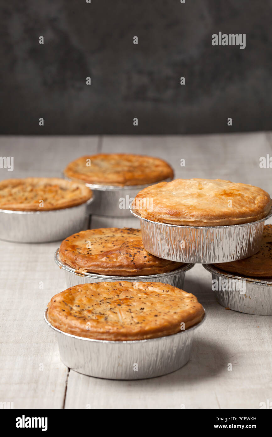 Upright image of meat pies in tin foil cases Stock Photo