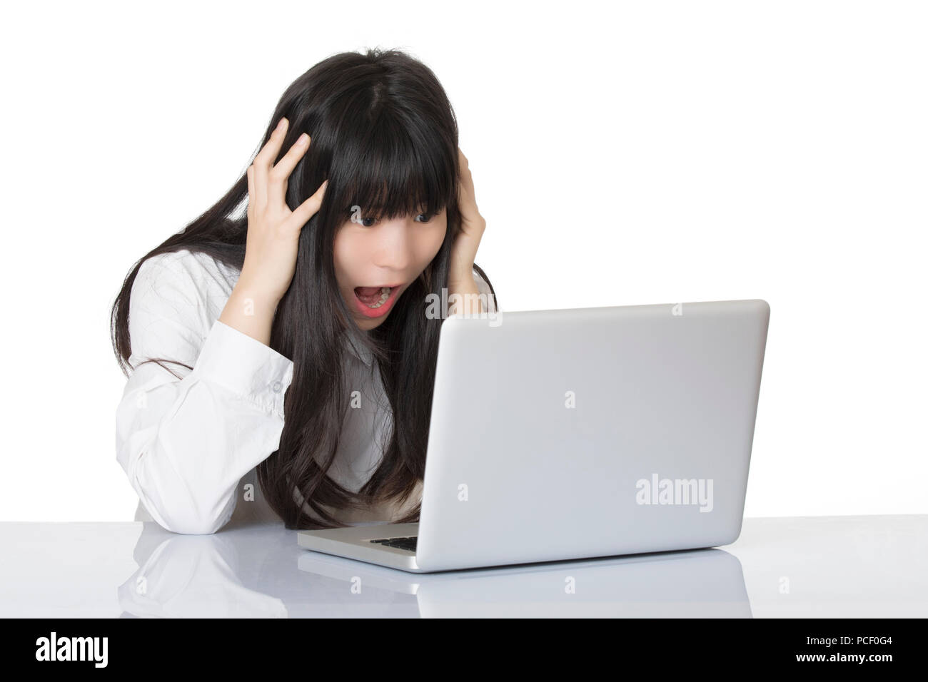 Beautiful Asian woman sitting at desk very stressed out isolated on a white background Stock Photo
