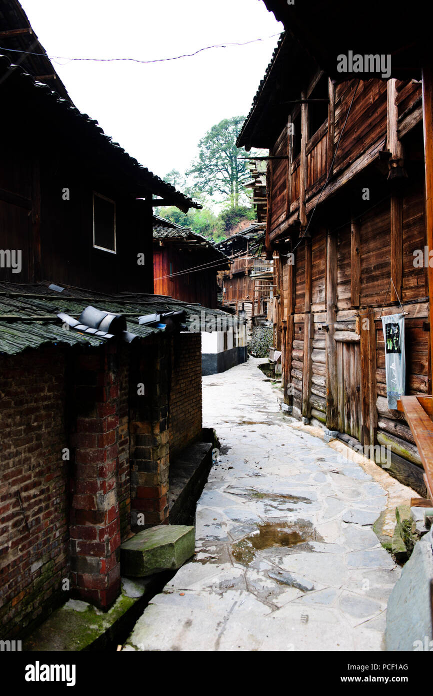 Typical Dong Village,Wooden Houses,Huanggang Dong Village,Dong Costumed Girls,Singing to Students,,Dwellings,Guizjou,PRC,People's Republic of China Stock Photo