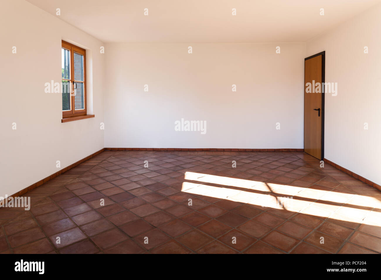 Architecture, interior, empty room with terracotta floor Stock Photo