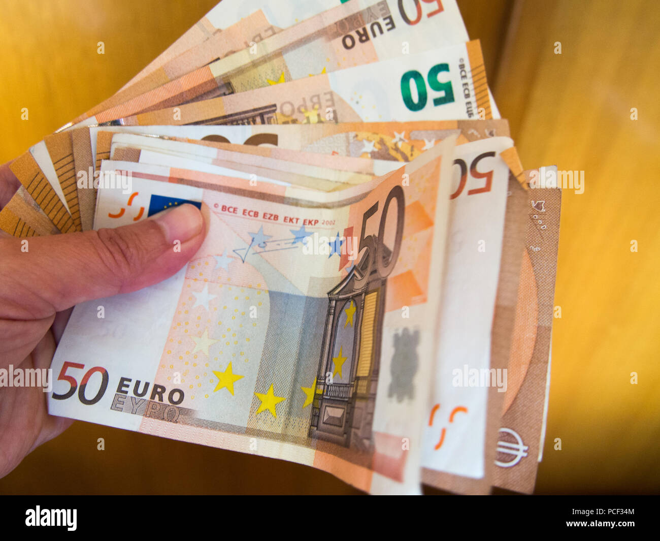 Hand with group of fifty euros banknotes Stock Photo