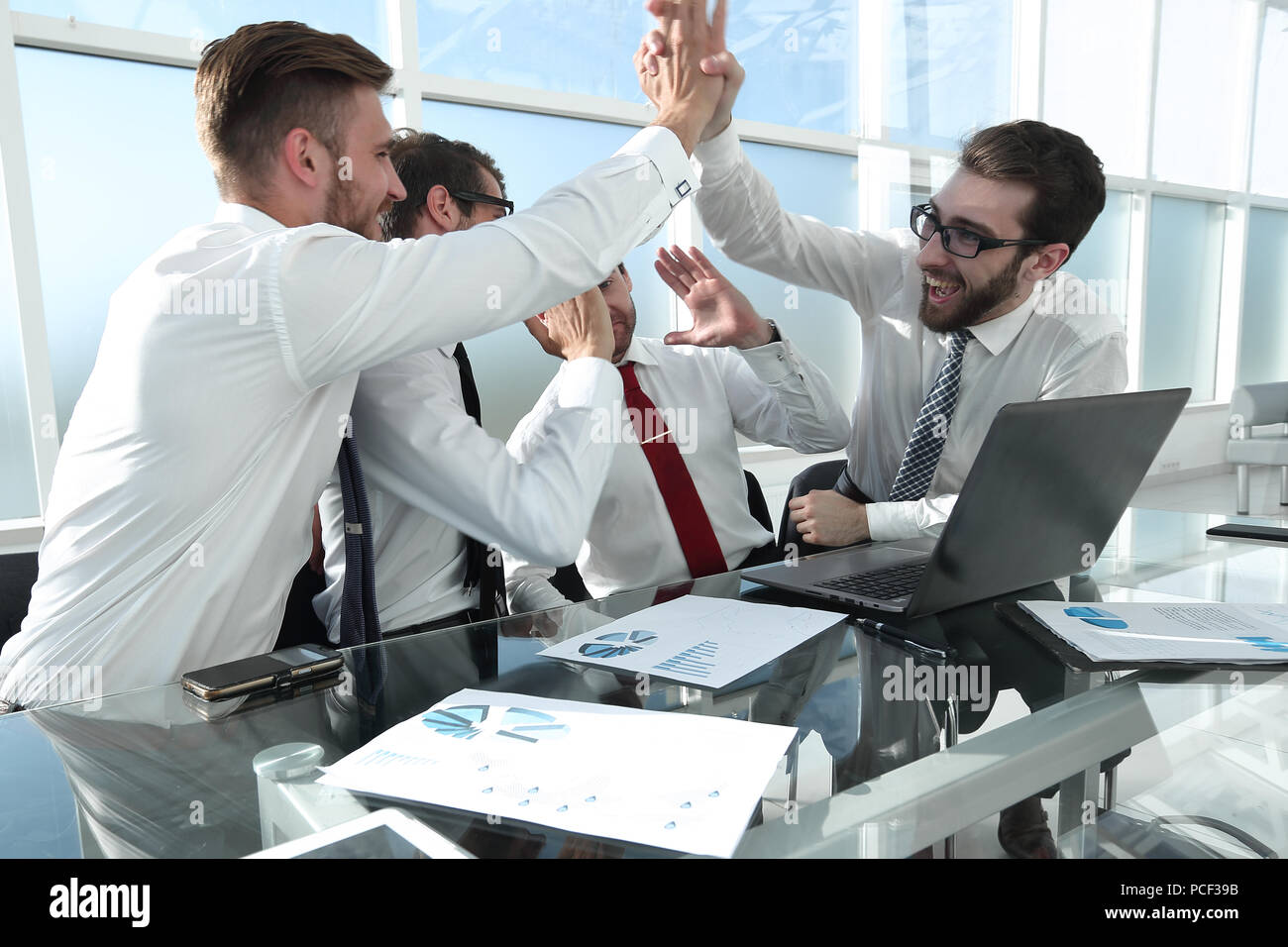 happy employees give each other a high five Stock Photo - Alamy