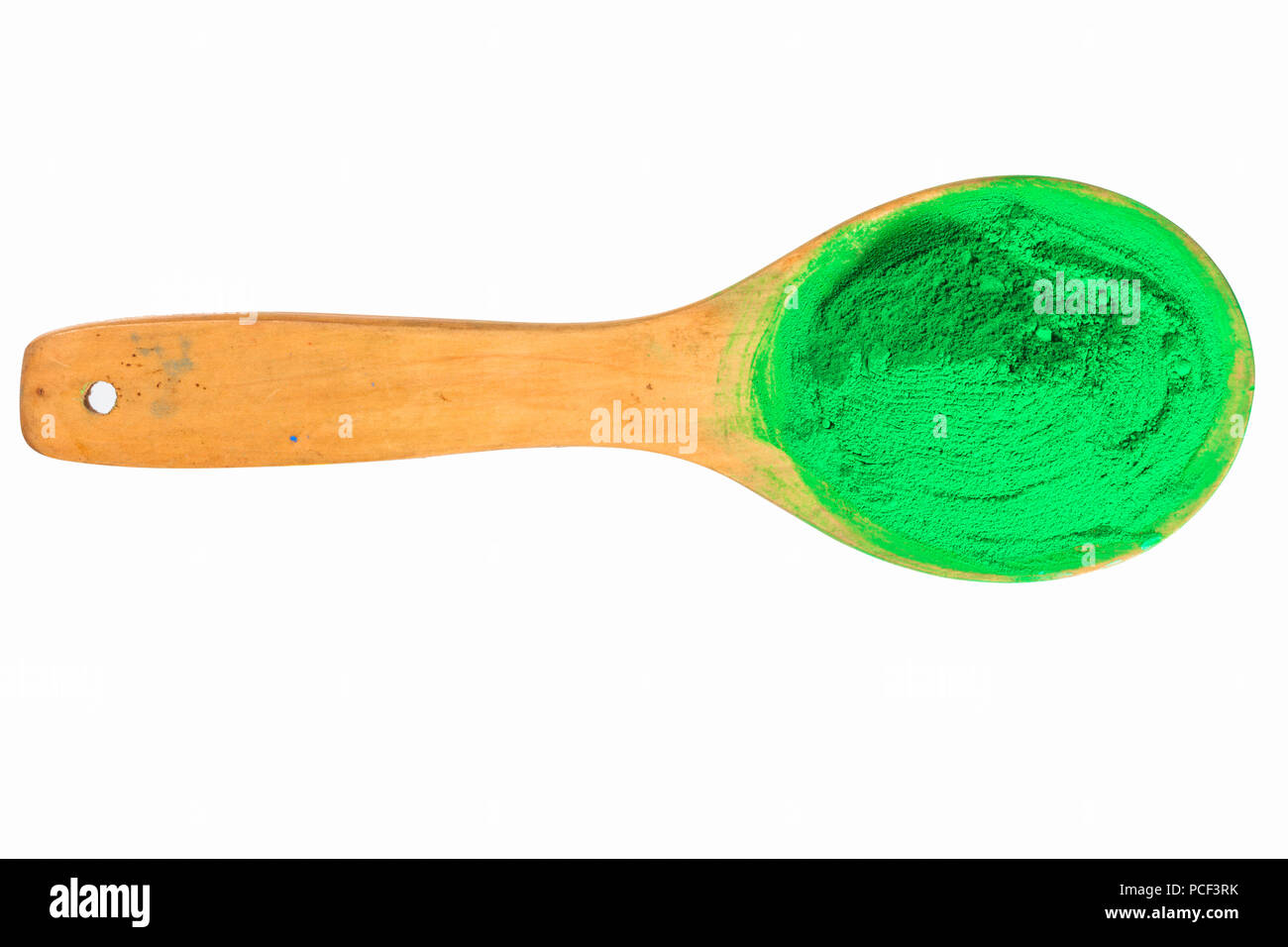 green powder on wooden spoon with clipping path in isolated on white ...