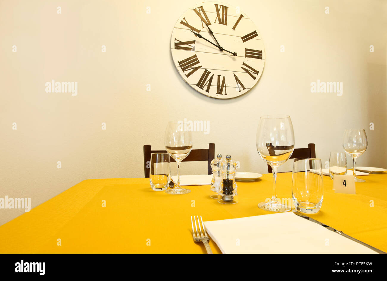 dining table and clock on the wall Stock Photo Alamy