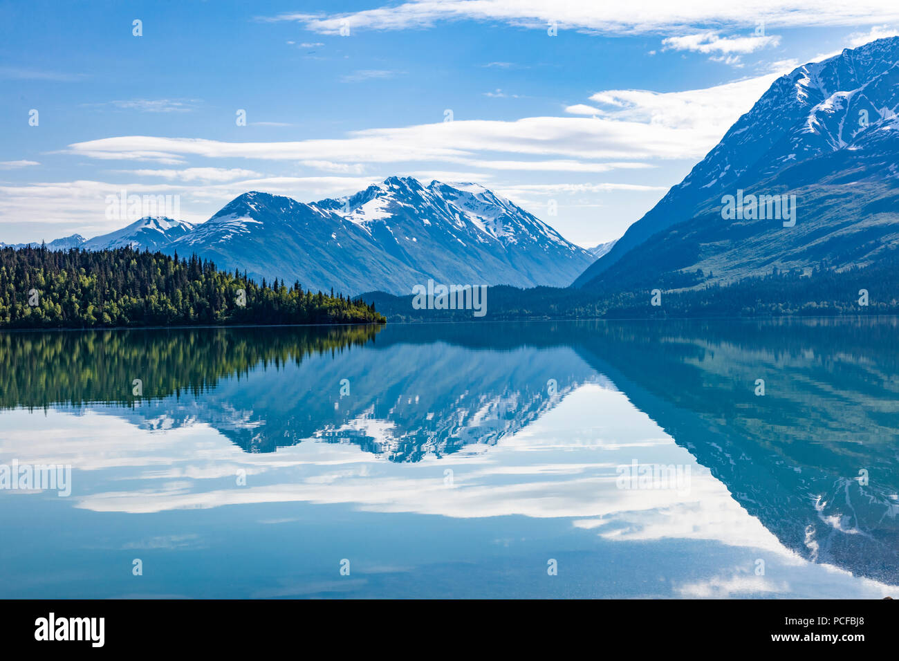 Mountains reflecting in Upper Trail Lake on the Kenai peninsula in Moose Pass Alaska Stock Photo