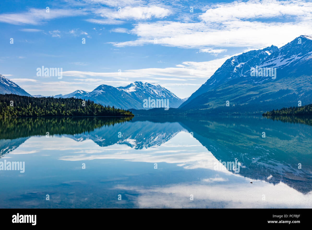 Mountains reflecting in Upper Trail Lake on the Kenai peninsula in Moose Pass Alaska Stock Photo