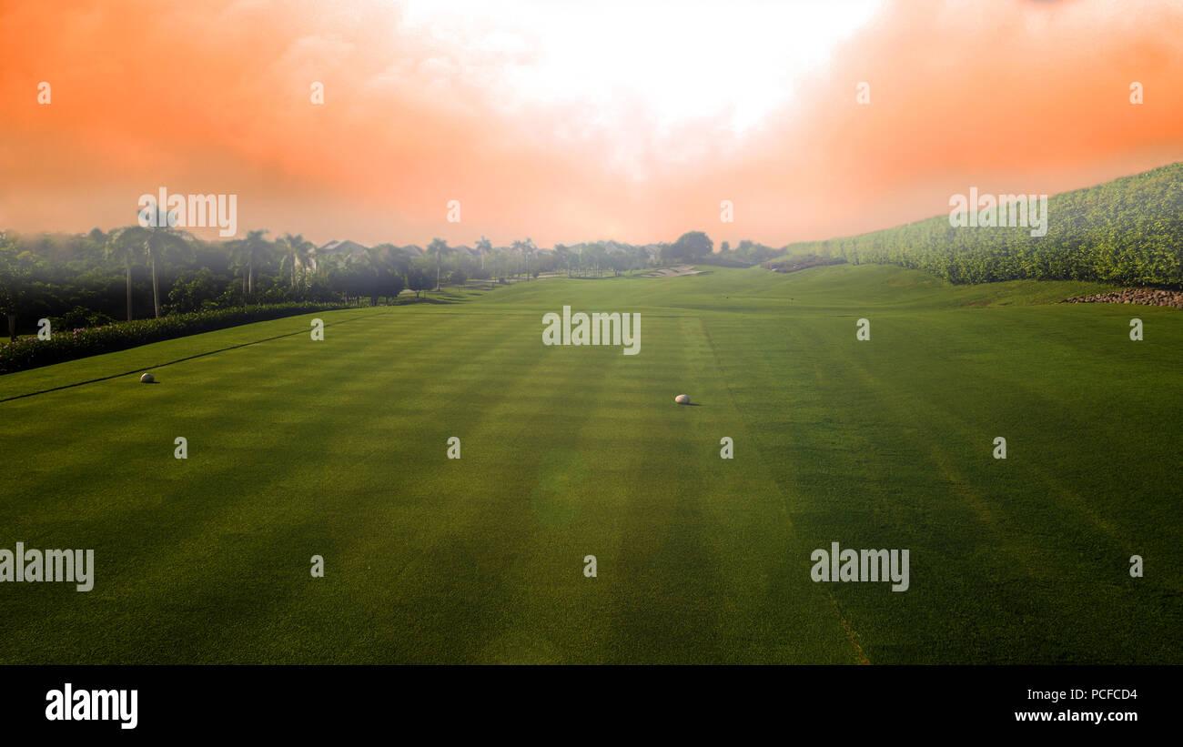 Beautiful golf course with the sun coming out in a foggy morning at the countryside of Panama Stock Photo