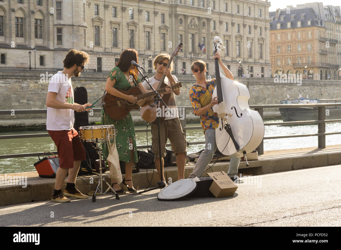 Street music band with double bass Paris - Street musicians playing at the embankment of the Seine River in Paris, France, Europe. Stock Photo