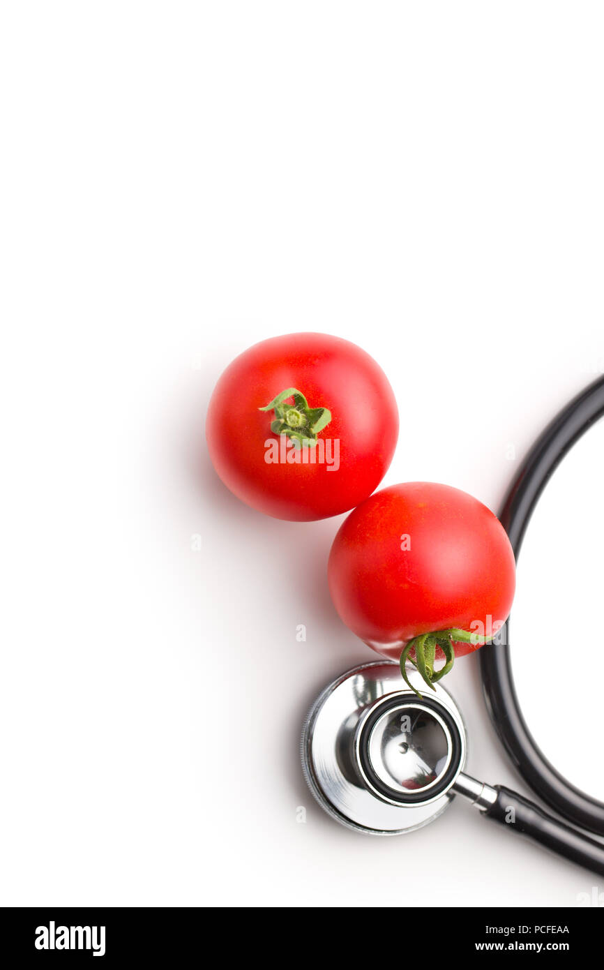 Red tomatoes and stethoscope isolated on white background. Stock Photo