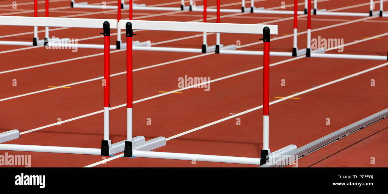 Hurdles on competition background Stock Photo Alamy
