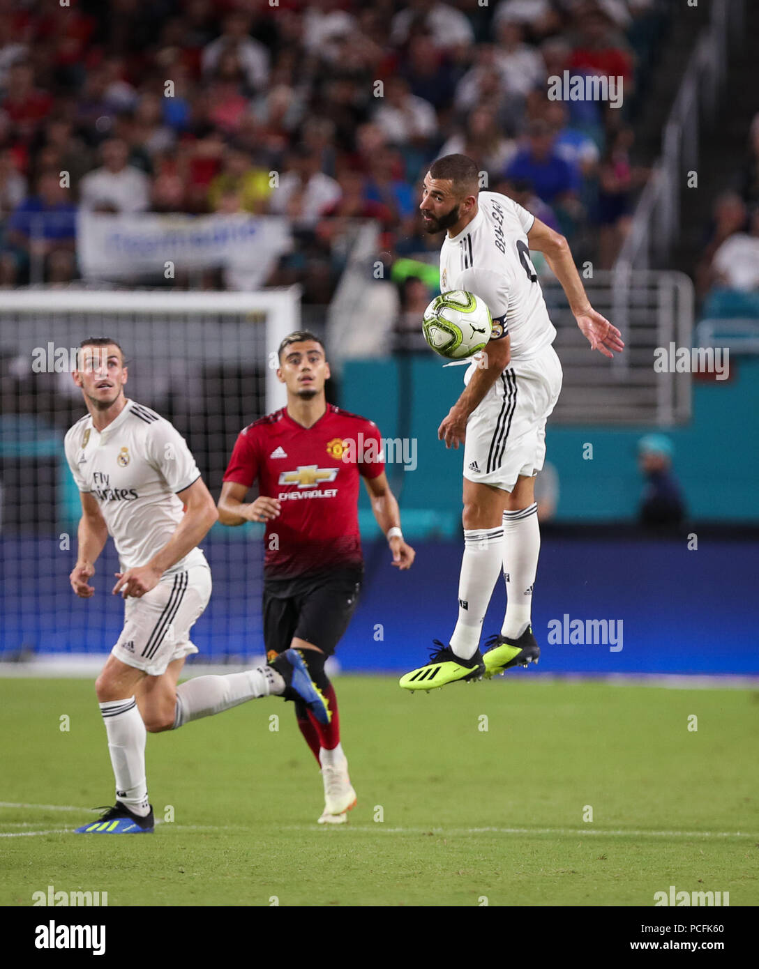 Miami Gardens, Florida, USA. 31st July, 2018. Real Madrid C.F. forward Karim Mostafa Benzema (9) leaps to pass the ball with a header, as Real Madrid C.F. forward Gareth Bale (11) (left) and Manchester United F.C. midfielder Andreas Pereira (15) (center) follow the action, during an International Champions Cup match between Real Madrid C.F. and Manchester United F.C. at the Hard Rock Stadium in Miami Gardens, Florida. Manchester United F.C. won the game 2-1. Credit: Mario Houben/ZUMA Wire/Alamy Live News Stock Photo