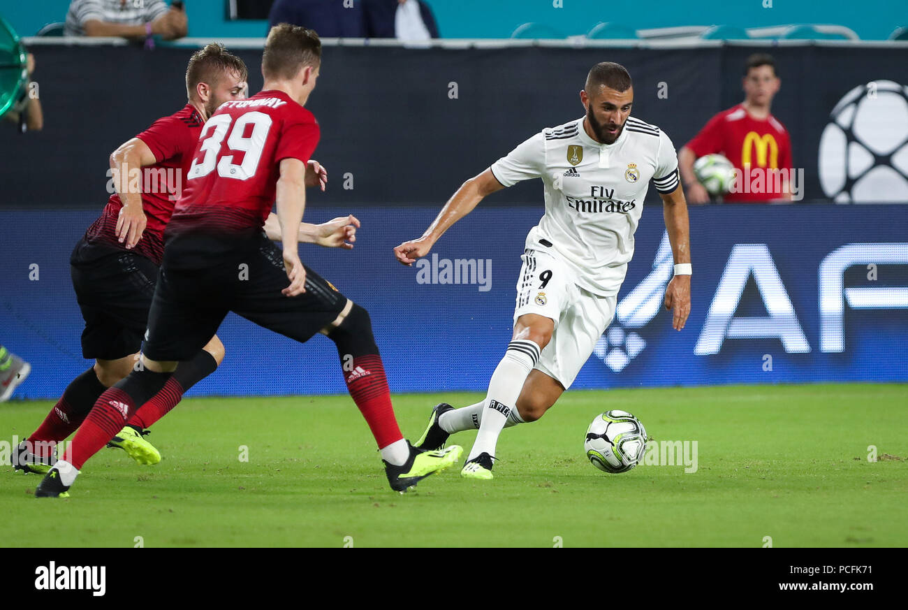 Miami Gardens, Florida, USA. 31st July, 2018. Real Madrid C.F. forward Karim Mostafa Benzema (9) drives the ball pressured by Manchester United F.C. midfielder Scott McTominay (39) and defender Luke Shaw (23) during an International Champions Cup match between Real Madrid C.F. and Manchester United F.C. at the Hard Rock Stadium in Miami Gardens, Florida. Manchester United F.C. won the game 2-1. Credit: Mario Houben/ZUMA Wire/Alamy Live News Stock Photo