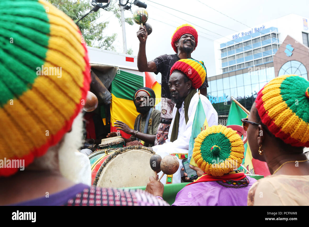 Port of Spain, Trinidad, Tobago. 1st Aug 2018. A Rastafarian group performs chants during the annual Emancipation Day observance procession from Independence Square to the Lidj Yasu Omowale Emancipation Village in the Queens' Park Savannah on August 1, 2018 in Port of Spain, Trinidad. (Photo by Sean Drakes/Alamy Live News) Stock Photo