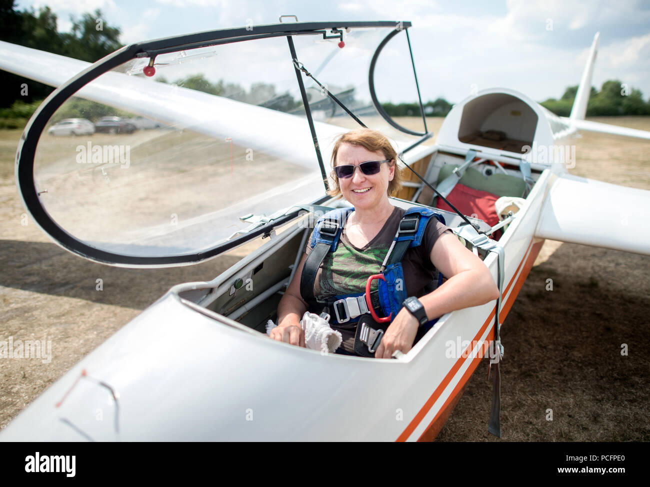 Burgdorf, Germany. 25th July, 2018. Astrid Angermann, longtime glider pilot of the Burgdorf Air Sports Club, sits in a glider on an airfield near Ramlingen. Credit: Hauke-Christian Dittrich/dpa/Alamy Live News Stock Photo