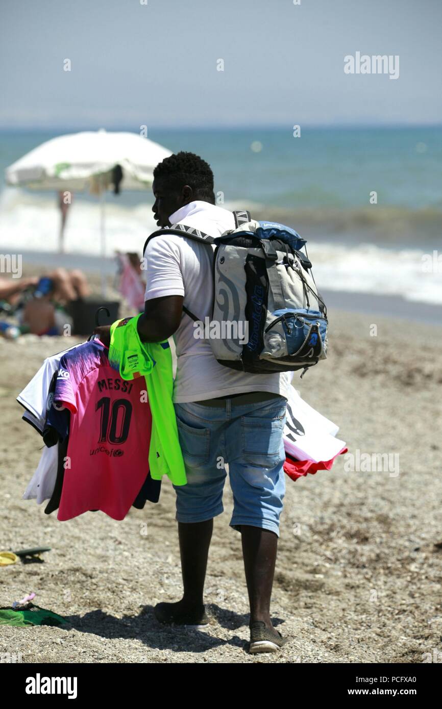 Roquetas de Mar, Almeria, Spain. 2nd Aug, 2018. The heatwave that is hitting Spain is expected to exceed 43°C in some parts of the country. Man selling beach items, t shirts walking along the seafront. Photo Credit: Paul Lawrenson /Alamy Live News Stock Photo