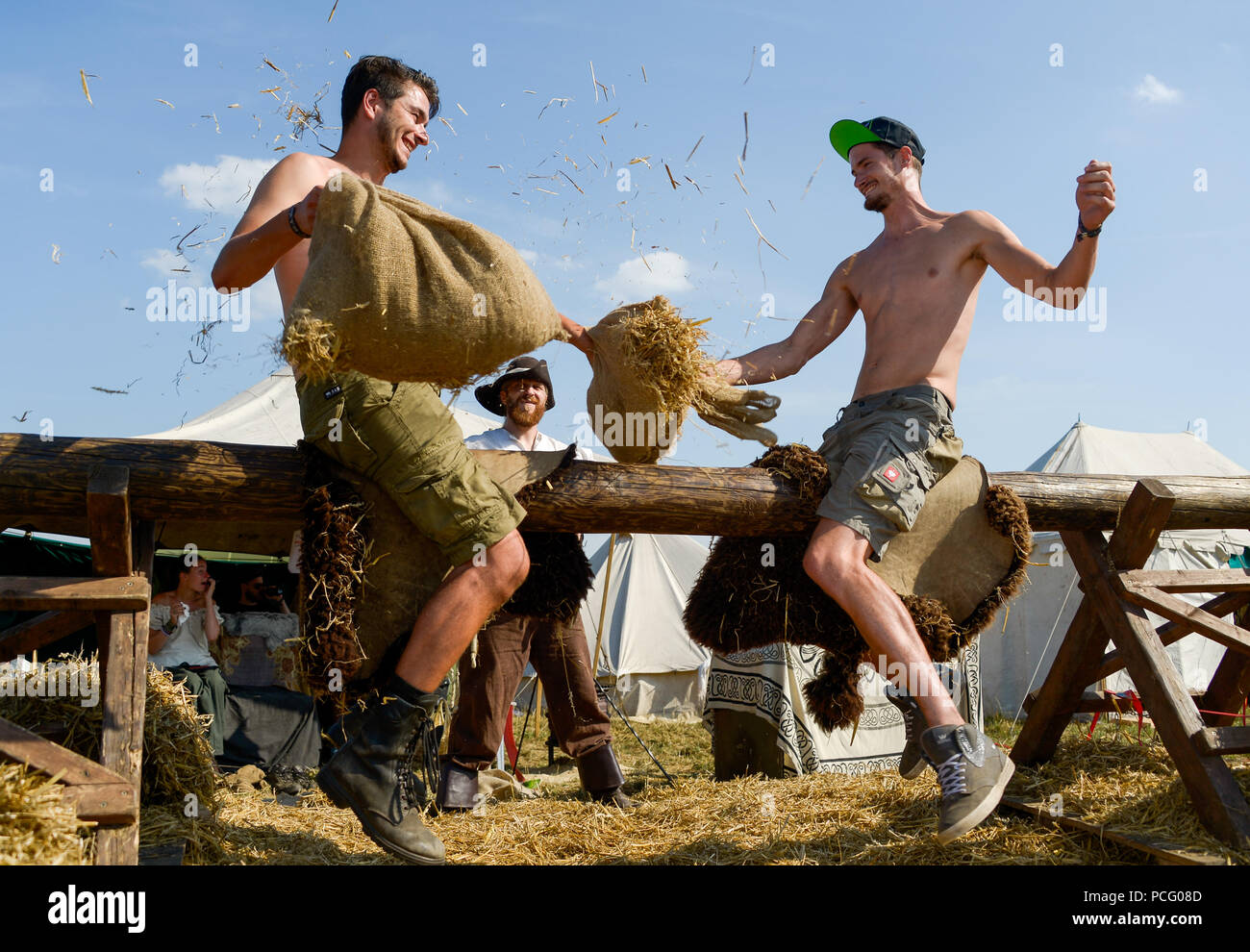 Wacken, Germany. 02nd Aug, 2018. Two festival visitors compete in the straw mattress competition at the Wacken Open Air. According to the organizers, the world's largest heavy metal festival starts with 75,000 visitors. Credit: Axel Heimken/dpa/Alamy Live News Stock Photo