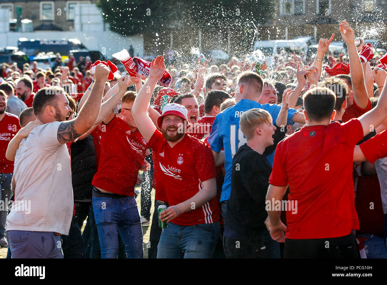 Aberdeen fans drink at the cricket ground next to the stadium before the UEFA Europa League Second Qualifying Round second leg match between Burnley and Aberdeen at Turf Moor on August 2nd 2018 in Burnley, England. (Photo by Daniel Chesterton/phcimages.com) Stock Photo