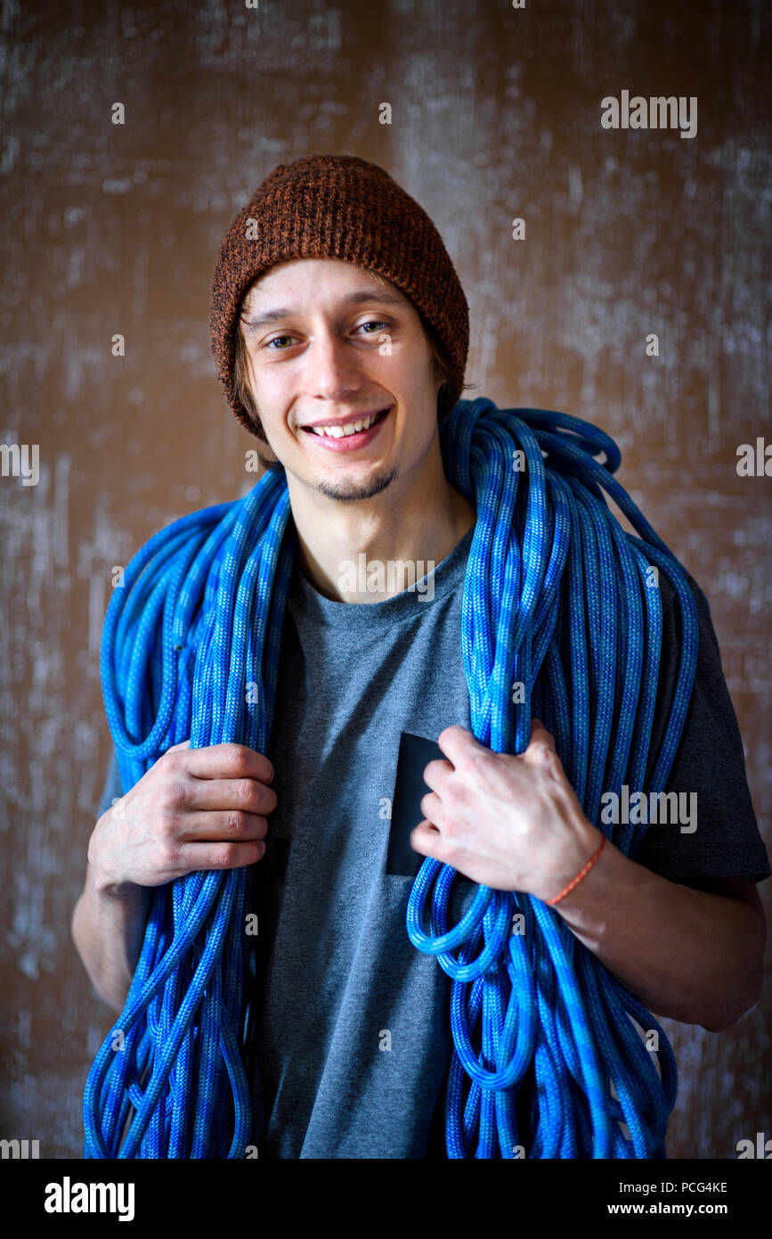 Sport concept. Happy young athlete, climber with a rope. Fitness and