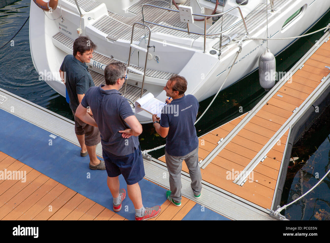 Sailway representatives discussing  nautical activities in the Ria de Vigo Spain at the port on deck side Stock Photo